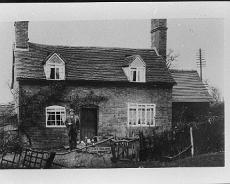 S0515 Canal Cottage which once stood on South bank of canal just west of the Tom O' the Wood. Picture shows Fred White. His daughters Dolly and Freda became Dolly...