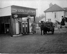 S0705 Lapworth Garage, corner of Station Lane, Mrs Hadley serving petrol