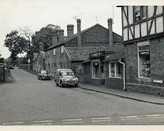 LHG01_0015 Doug Morris Electrical shop at corner of Mill Lane c1956. Bird in Hand Cottages beyond. The Bird in Hand pub was the last building before the canal bridge. The...