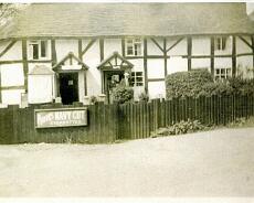 img20211208_0093 Foxbrook Cottage. 'Shed Shop' gone, the shop now in the left hand cottage. Mr and Mrs Wall standing in the doorway